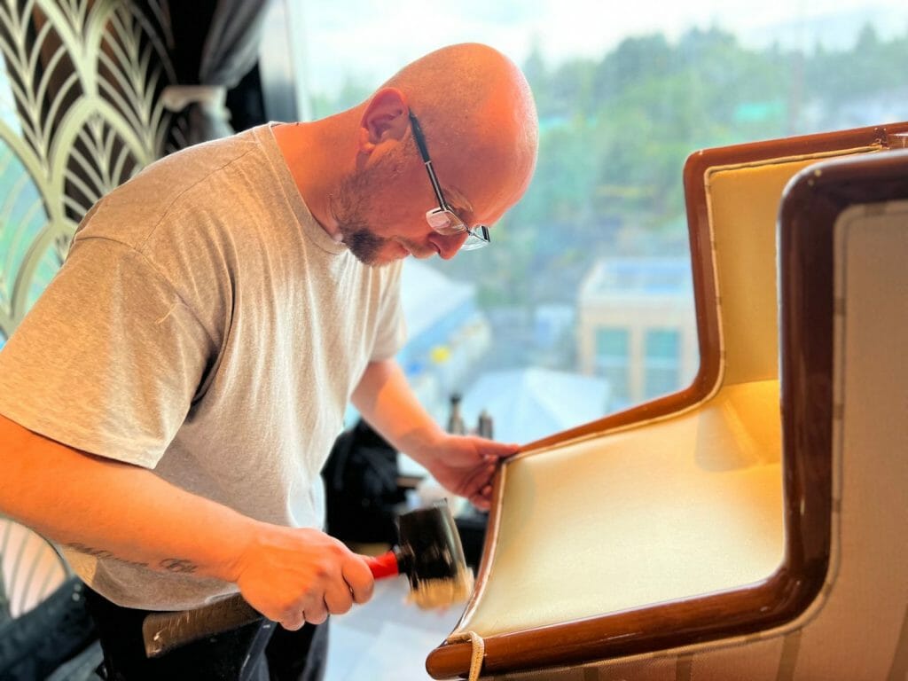 Man with a hammer building a sofa 