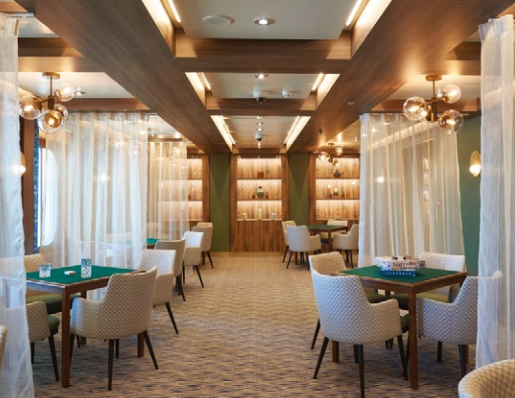 Dining area with sheer fabric between tables 